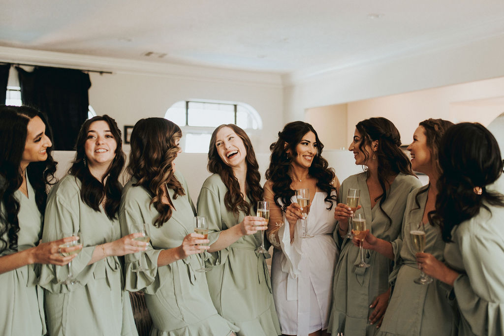 bridesmaids getting ready with champagne