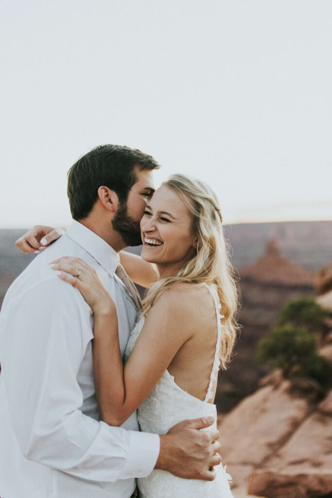couple taking photos after eloping at dead horse point state park