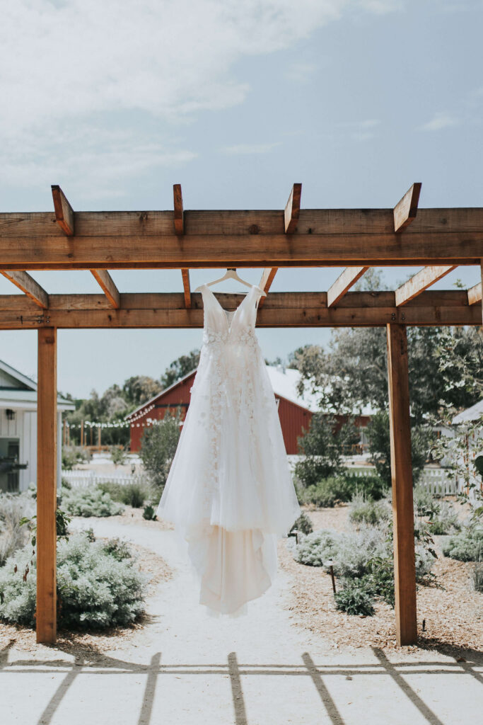 Wedding Dress Hanging Detail Shot on Summer Wedding Day