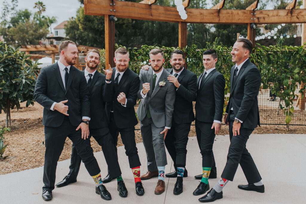 groomsmen show off themed socks