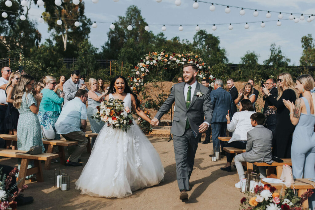bride and groom running down aisle after wedding ceremony