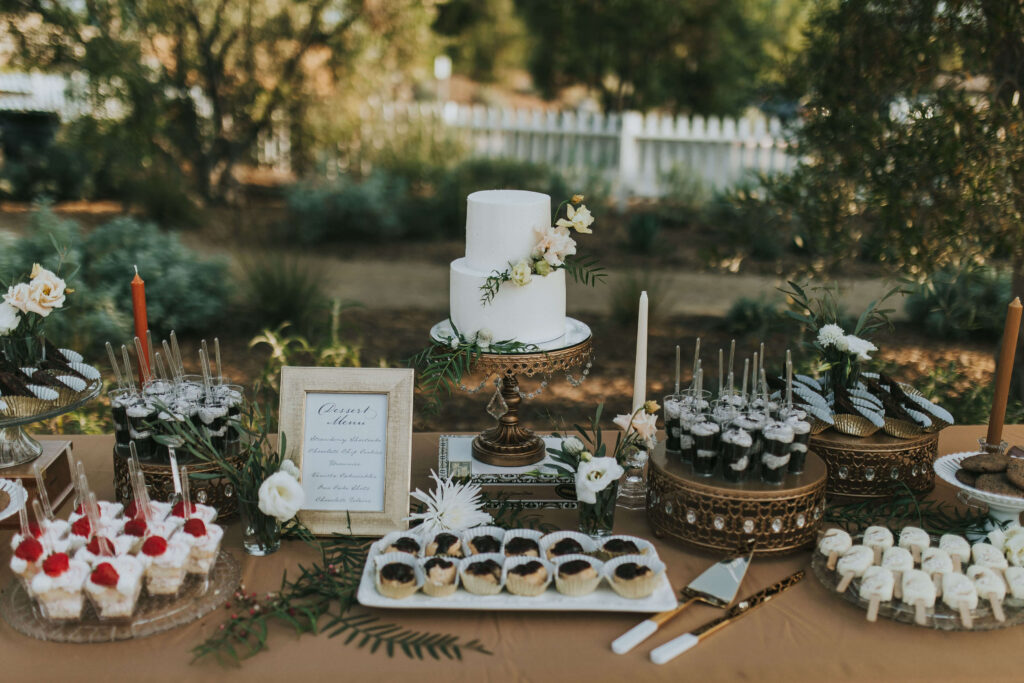 wedding dessert tables with cake and other handmade sweets