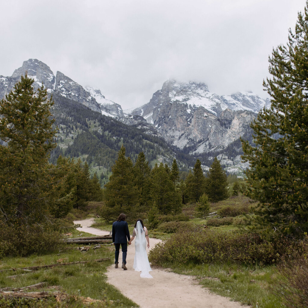bride and groom hike on their adventure elopement day