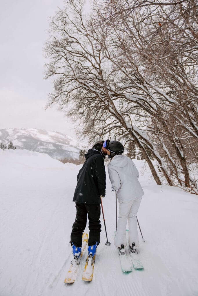 Bride and groom hit the slopes at Snowbasin Ski Resort on their winter wedding day.