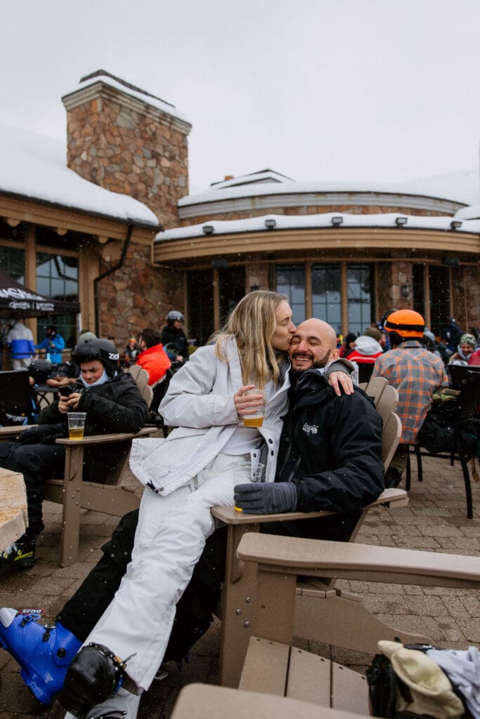 bride and groom enjoy local craft beer at snowbasin ski resort on their winter elopement day