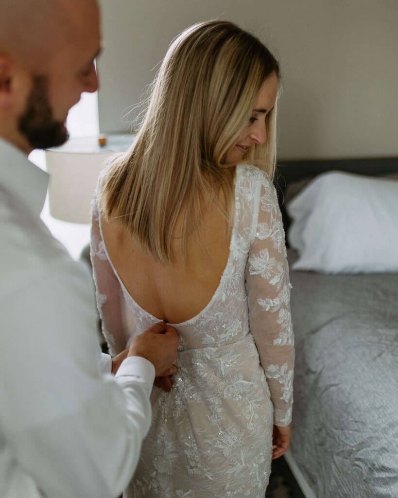 bride and groom get ready together on their winter elopement day