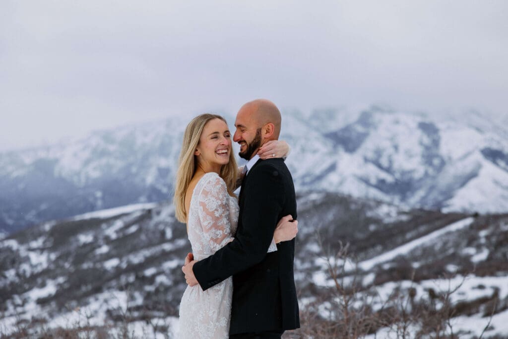 bride and groom get married at a snowy mountain overlook in utah