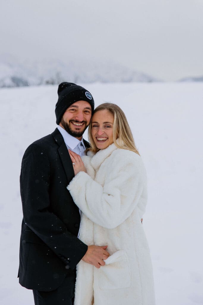 bride and groom at a snowy mountain overlook near Snowbasin ski resort in Ogden, Utah