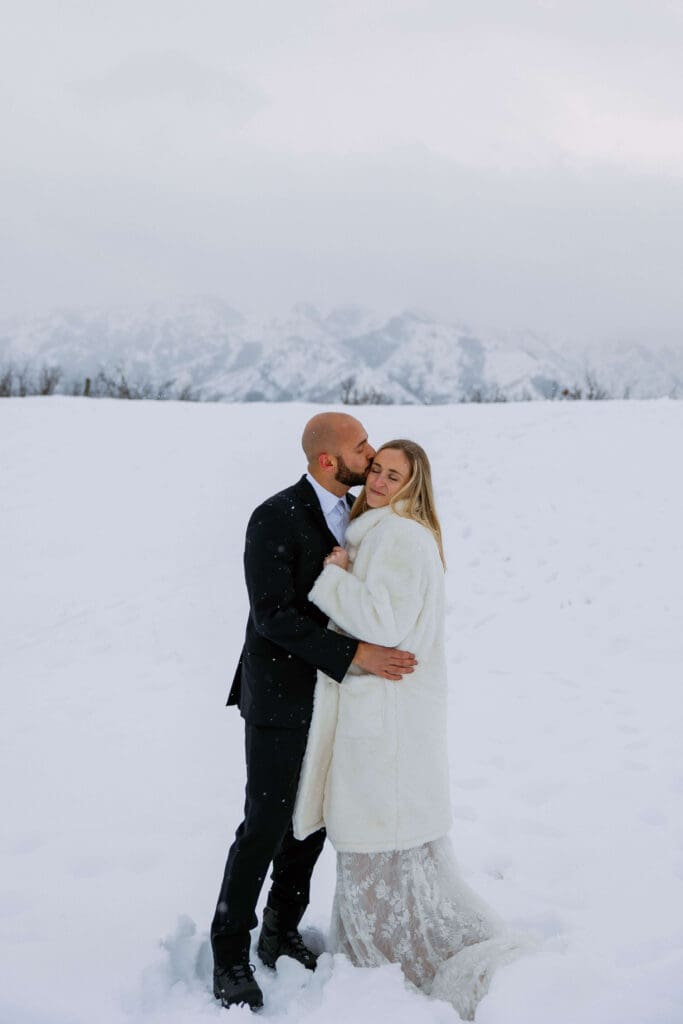 bride and groom on their snowy elopement day in utah