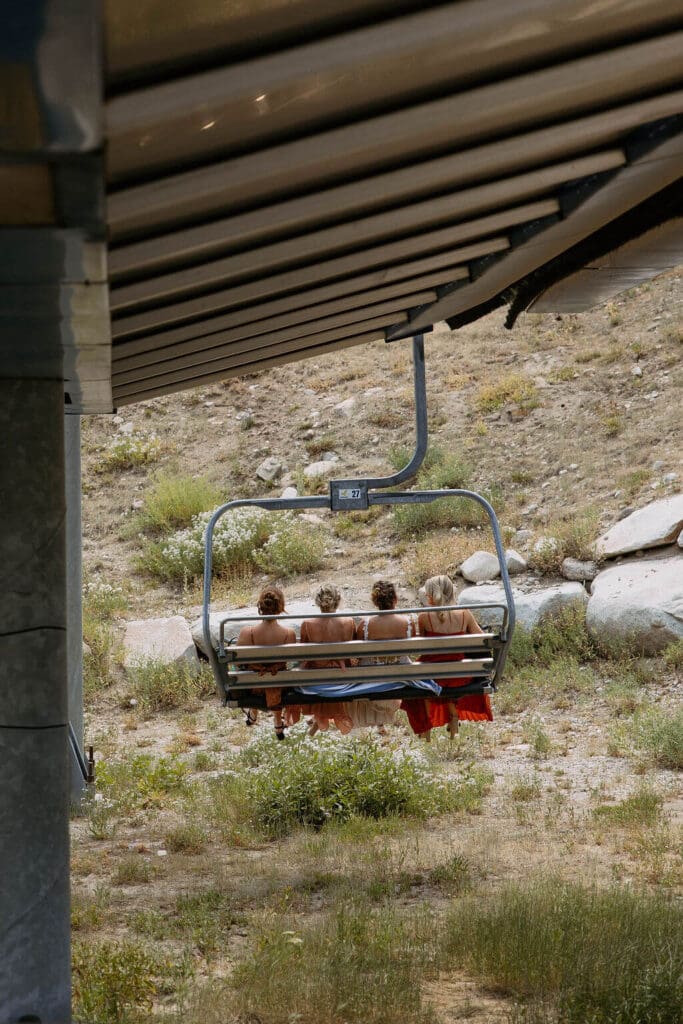 bride takes chairlift up to mountain wedding ceremony
