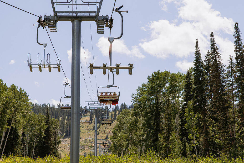 bride takes charilift up to mountain wedding ceremony