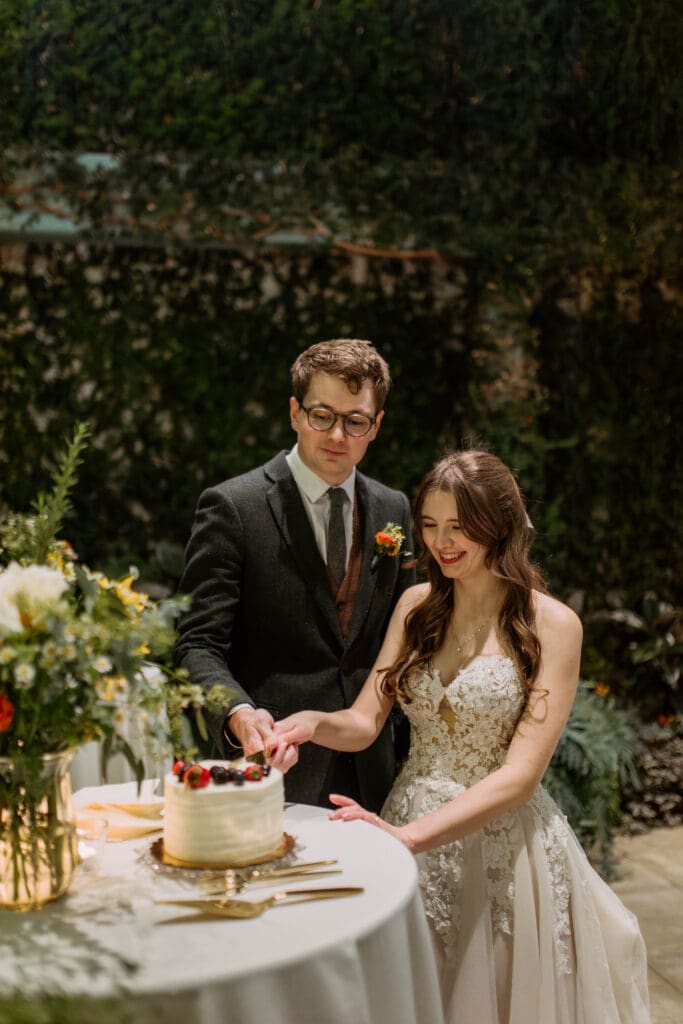 bride and groom cut cake at red butte garden