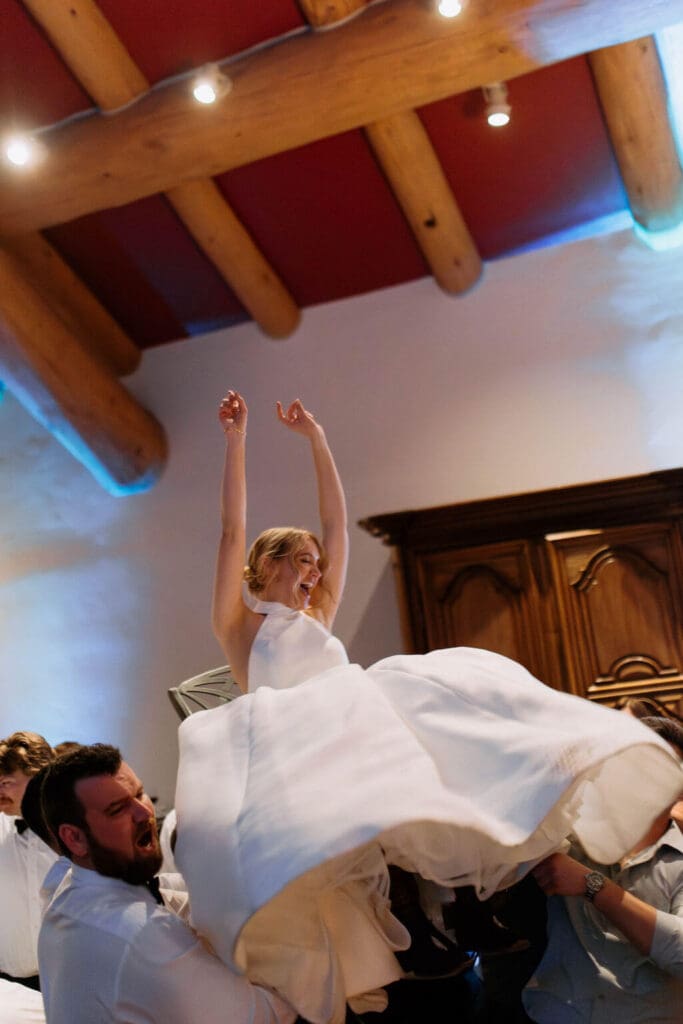 the hora - bride lifted into air on a chair for traditional jewish dance