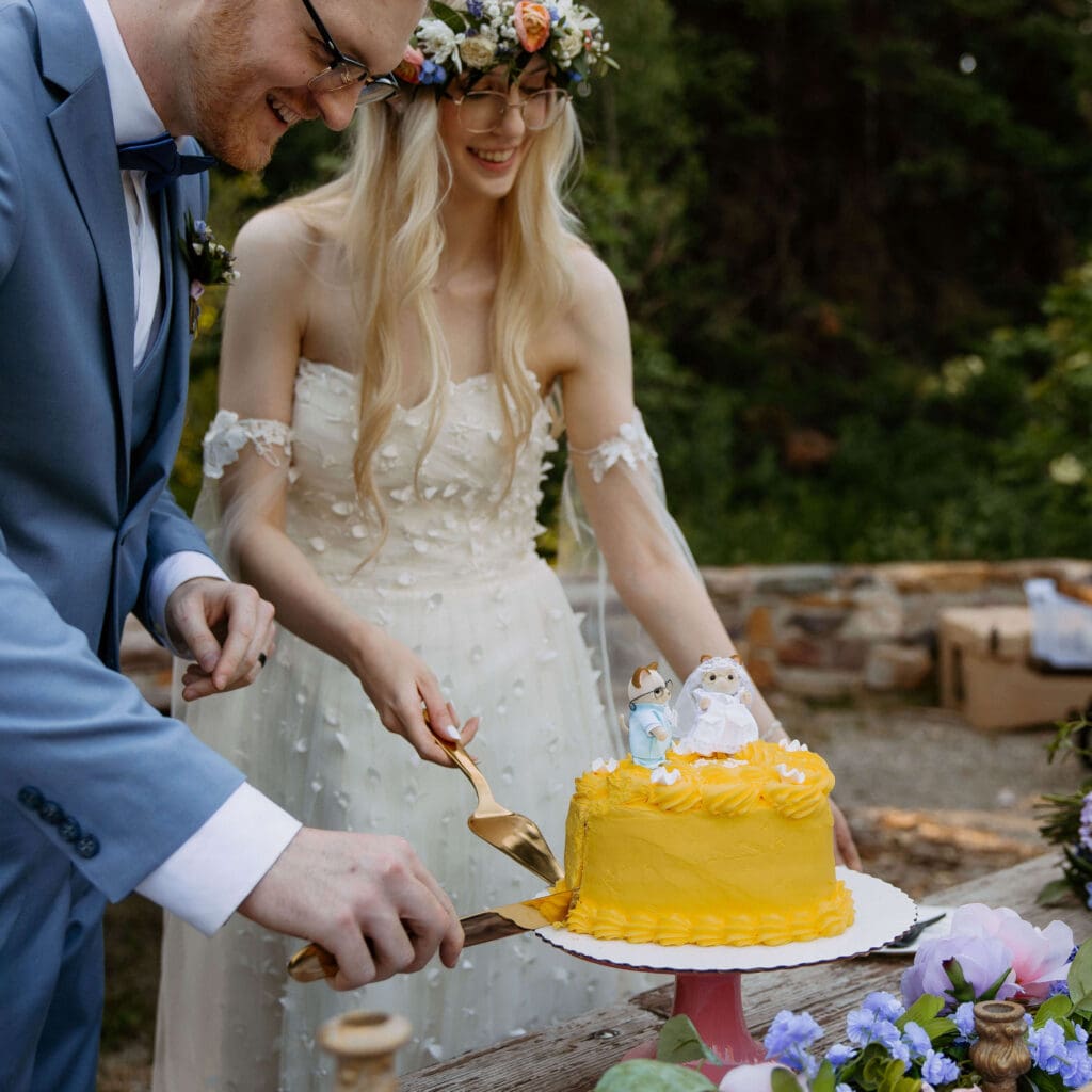 bride and groom cut cake