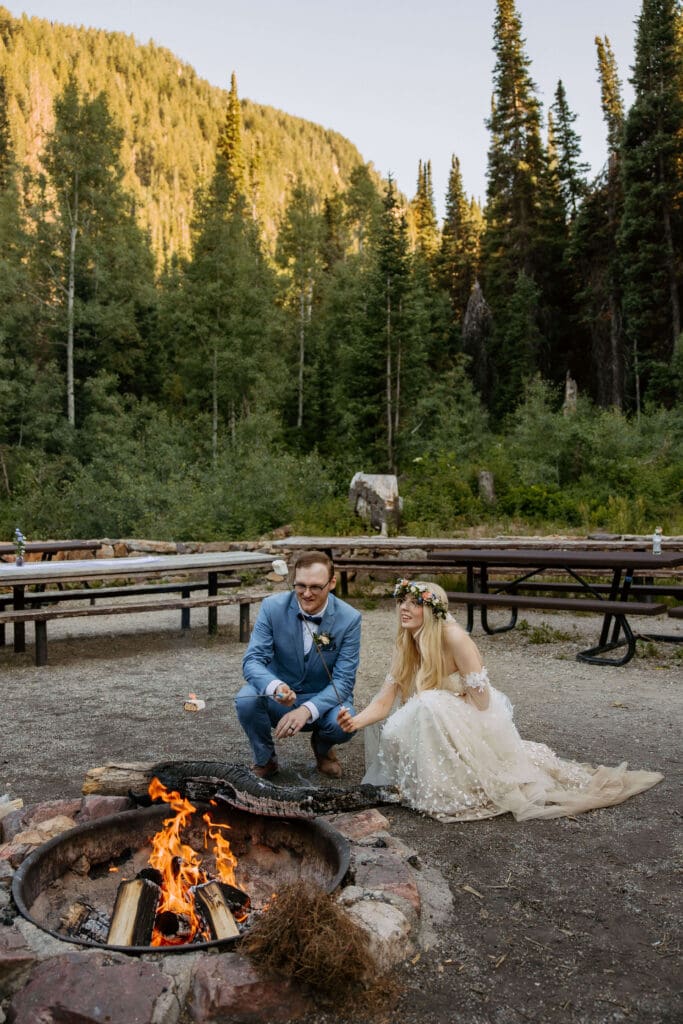 bride and groom make s'mores on adventure elopement day
