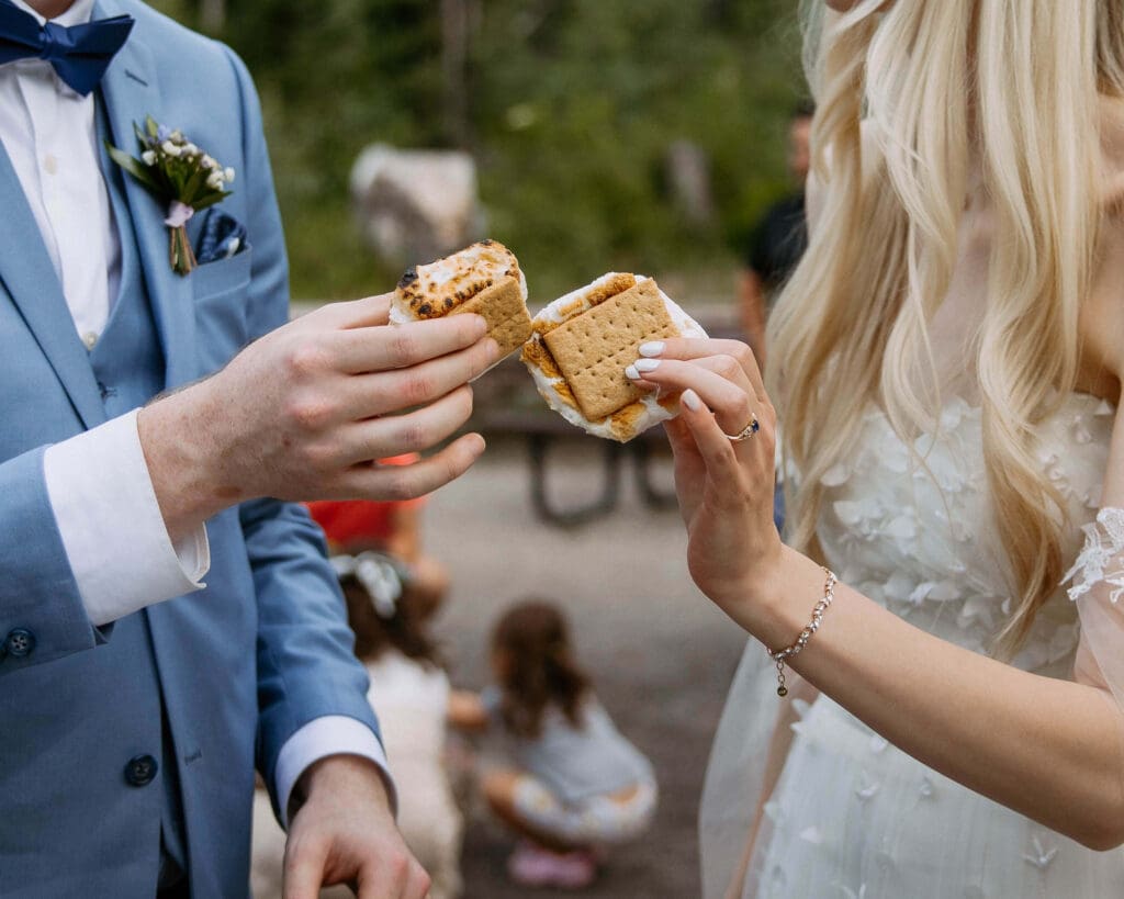 bride and groom making s'mores on wedding day