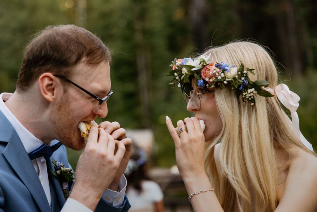 bride and groom eating s'mores on wedding day