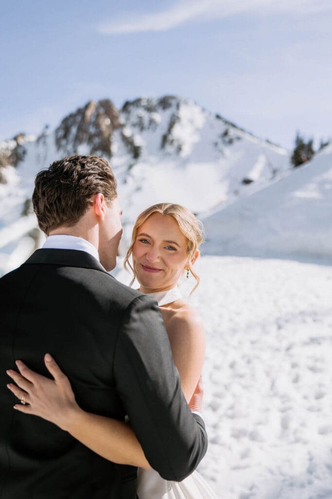 bride looking over grooms shoulder at snowbasin resort
