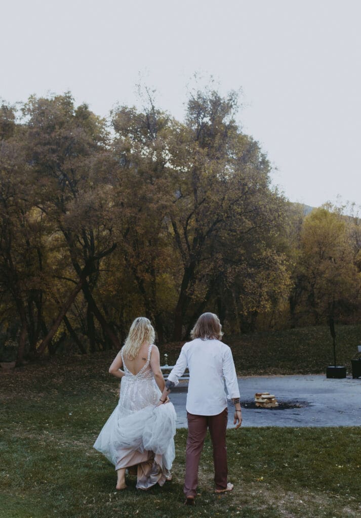 bride and groom build campfire on elopement day