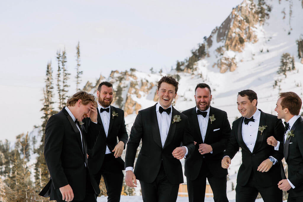 groomsmen laughing at winter wedding