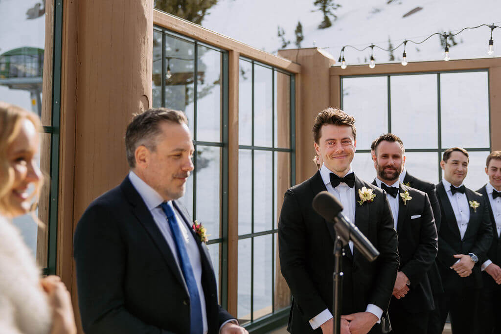 groom looking at bride lovingly during winter wedding ceremony