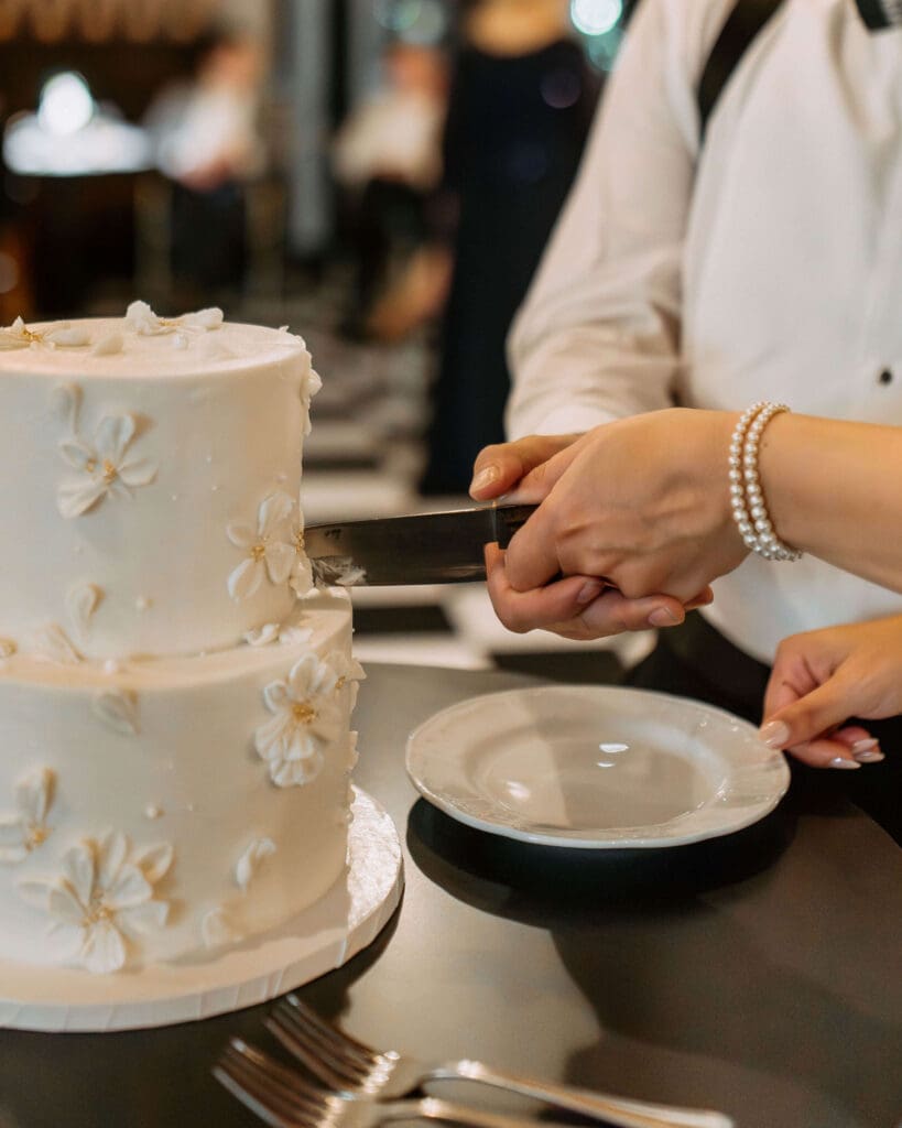 bride and groom cut the cake at small wedding reception in utah