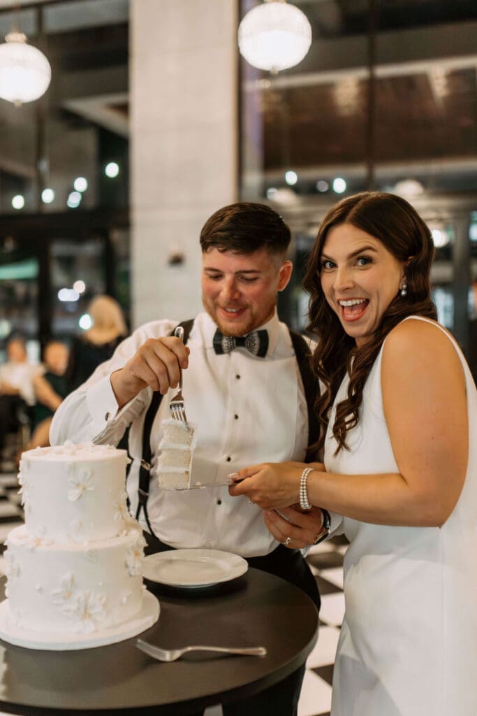 bride and groom cut the cake at small wedding reception venue in utah