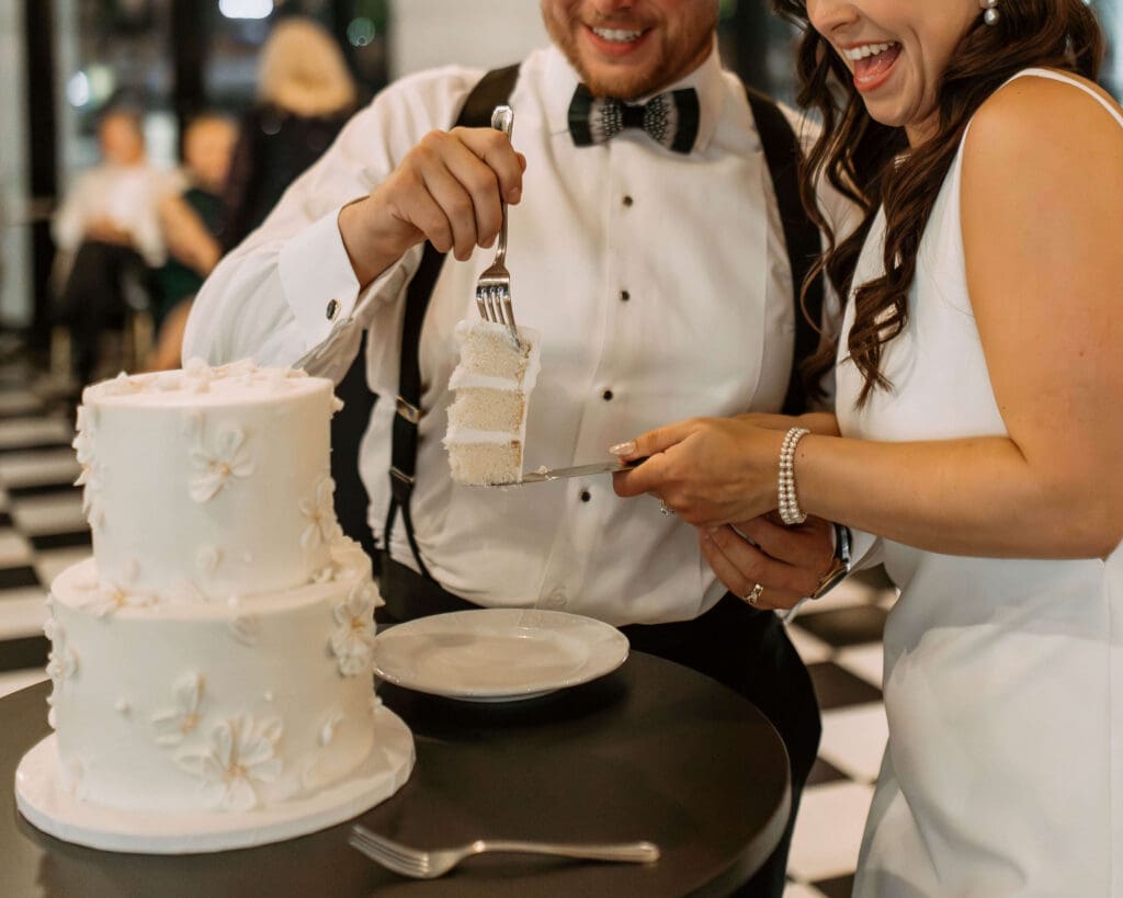 bride and groom cut the cake at small wedding reception in utah