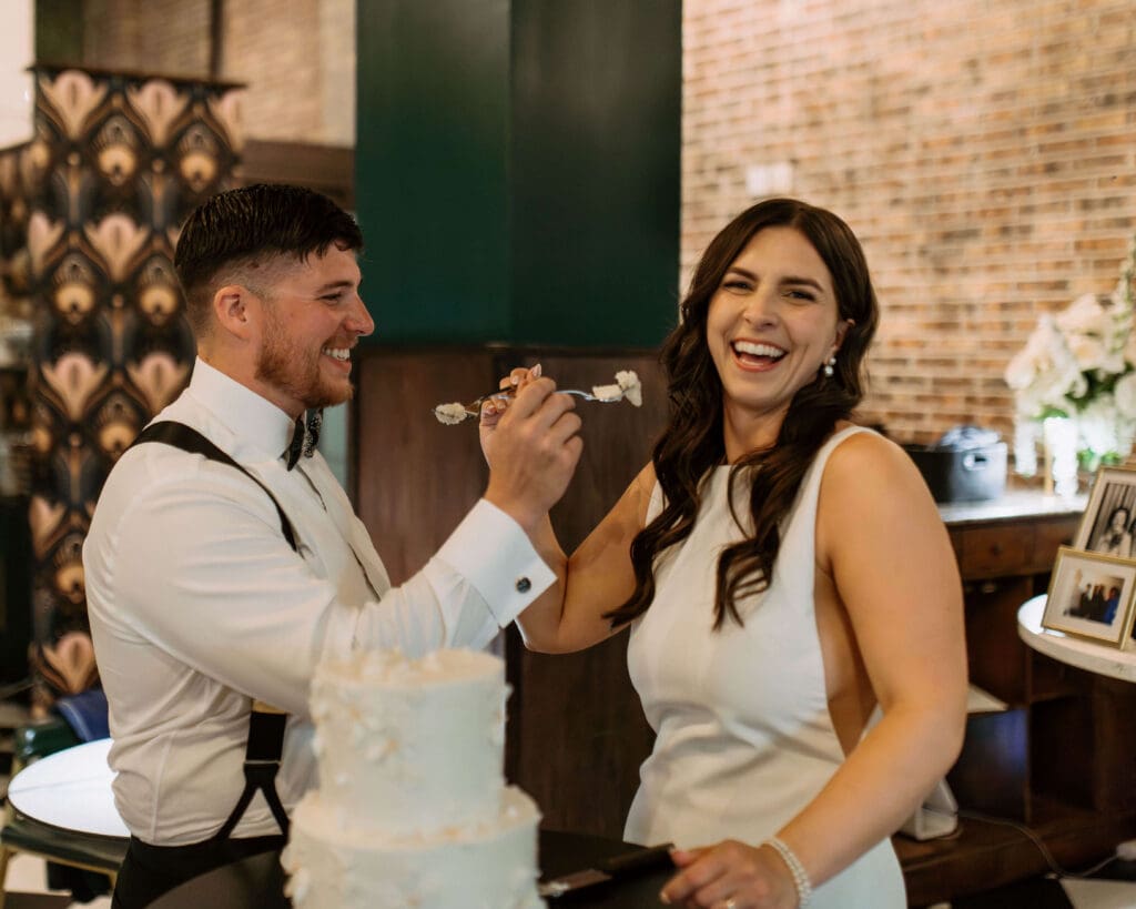 bride and groom cut the cake at small wedding reception after mountain wedding day