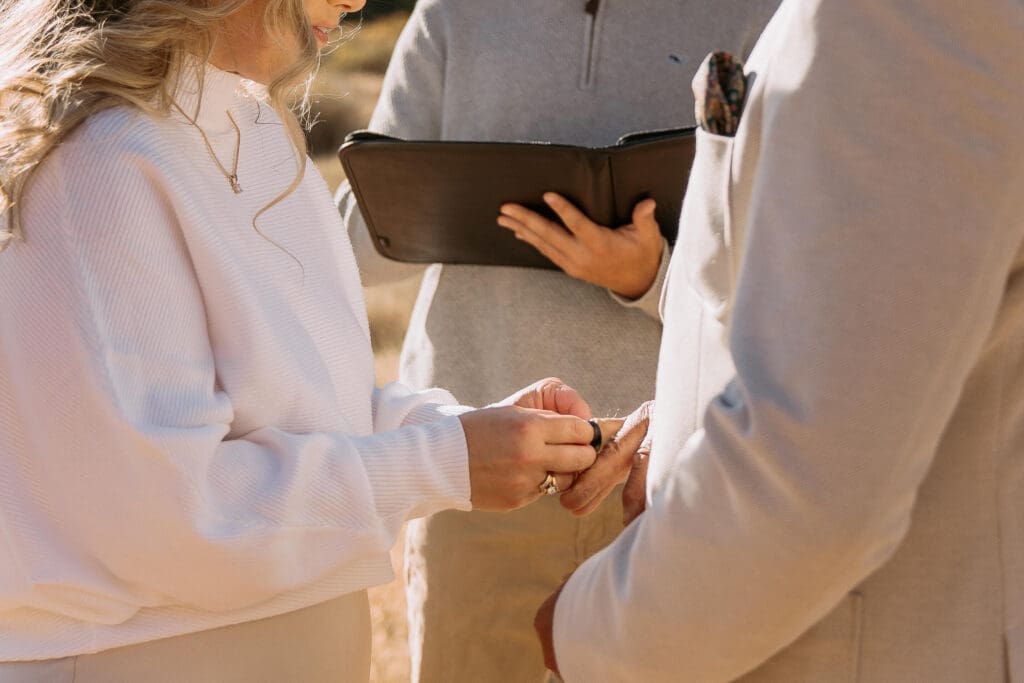bride and groom exchanging wedding rings in zion national park