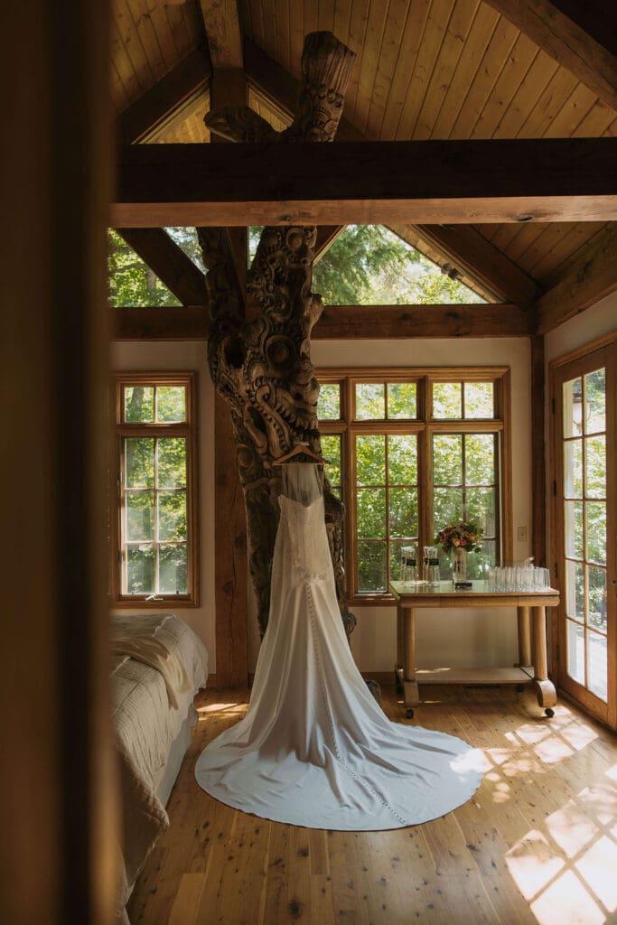 wedding dress hanging in cabin at intimate wedding